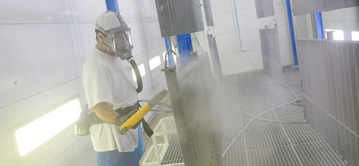 Man in mask using powder coating tools | Brisbane sandblasting